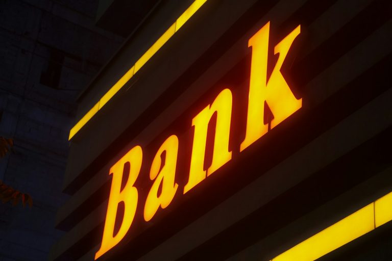 IFSC Code Structure Decoded: Complete Guide to All 11 Characters and Meaning a bank sign lit up in the dark