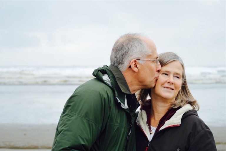 Senior citizen elderly couple enjoying happy retirement with SCSS pension savings income